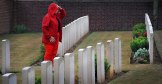 Fiona puts a poppy down at an unknown Soldiers grave on the way to Arras